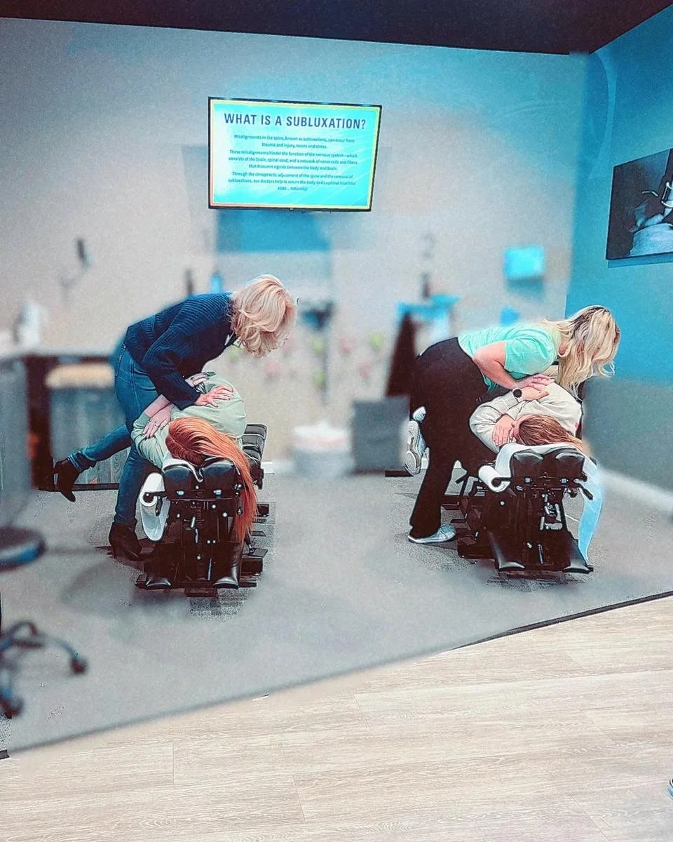 Chiropractors adjusting patients in the House of Chiropractic treatment room