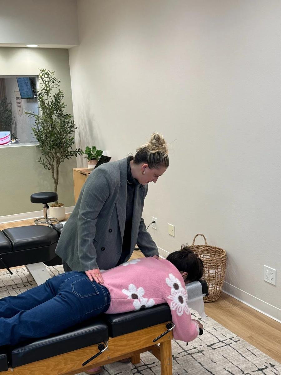 Chiropractor performing a lumbar adjustment to relieve lower back pain