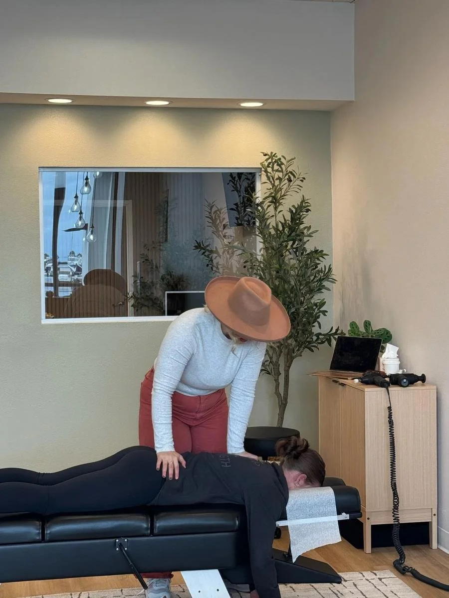 Chiropractor adjusting a patient's lower back for back pain relief in Huntington Beach