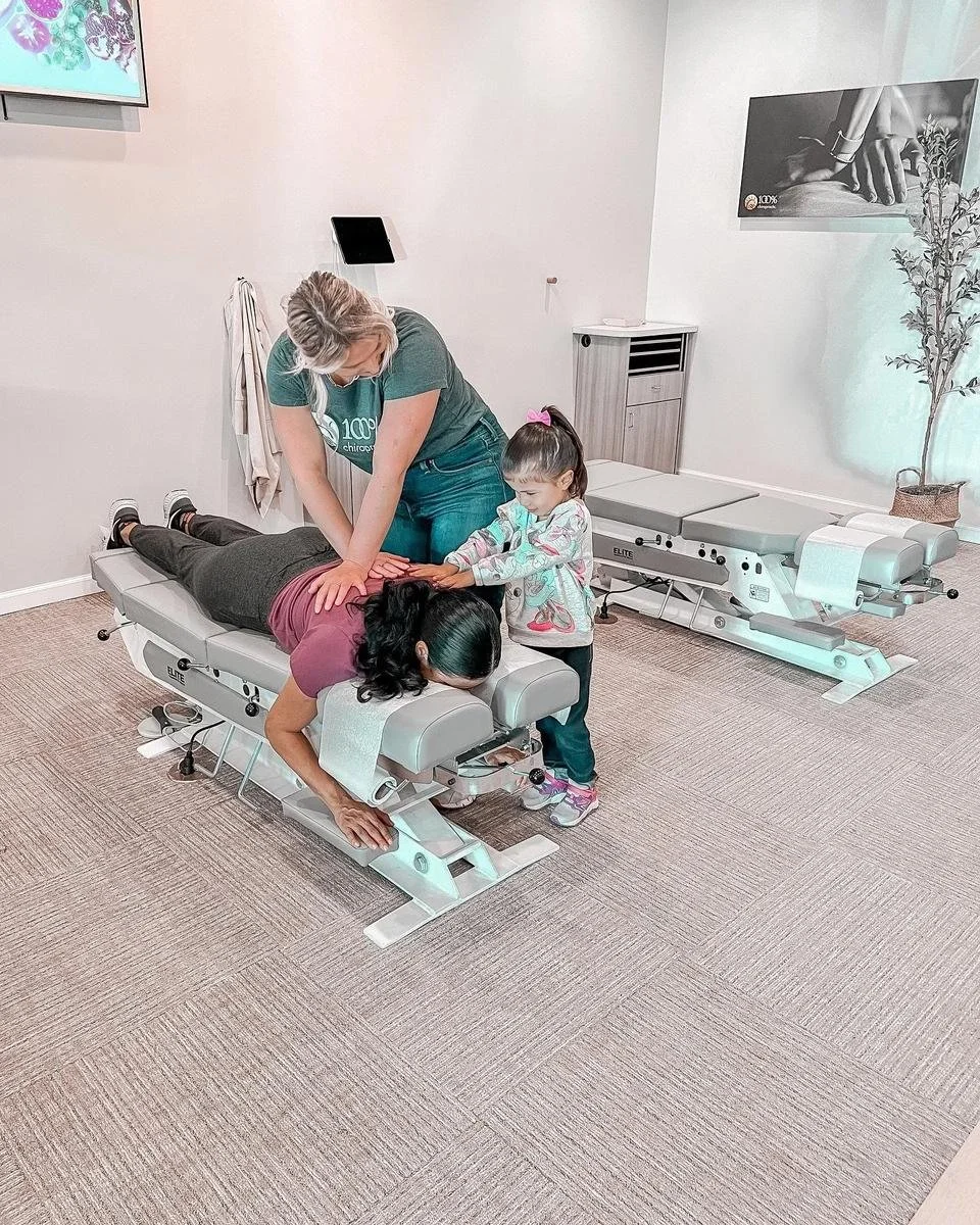Chiropractor adjusting a patient on a drop table during scoliosis care