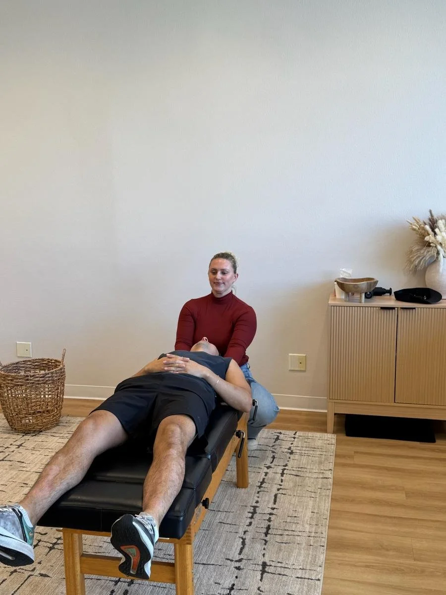Dr. Corrin Harris performing a chiropractic adjustment on a patient