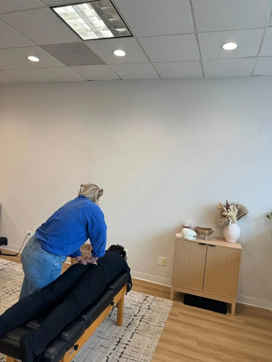 Chiropractor adjusting a patient's low back during a back pain visit