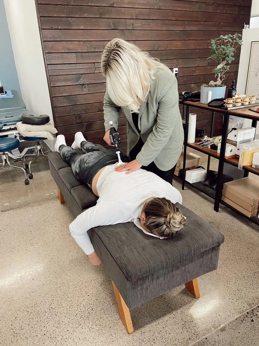 Chiropractor using an adjusting instrument to support nervous system regulation in Huntington Beach