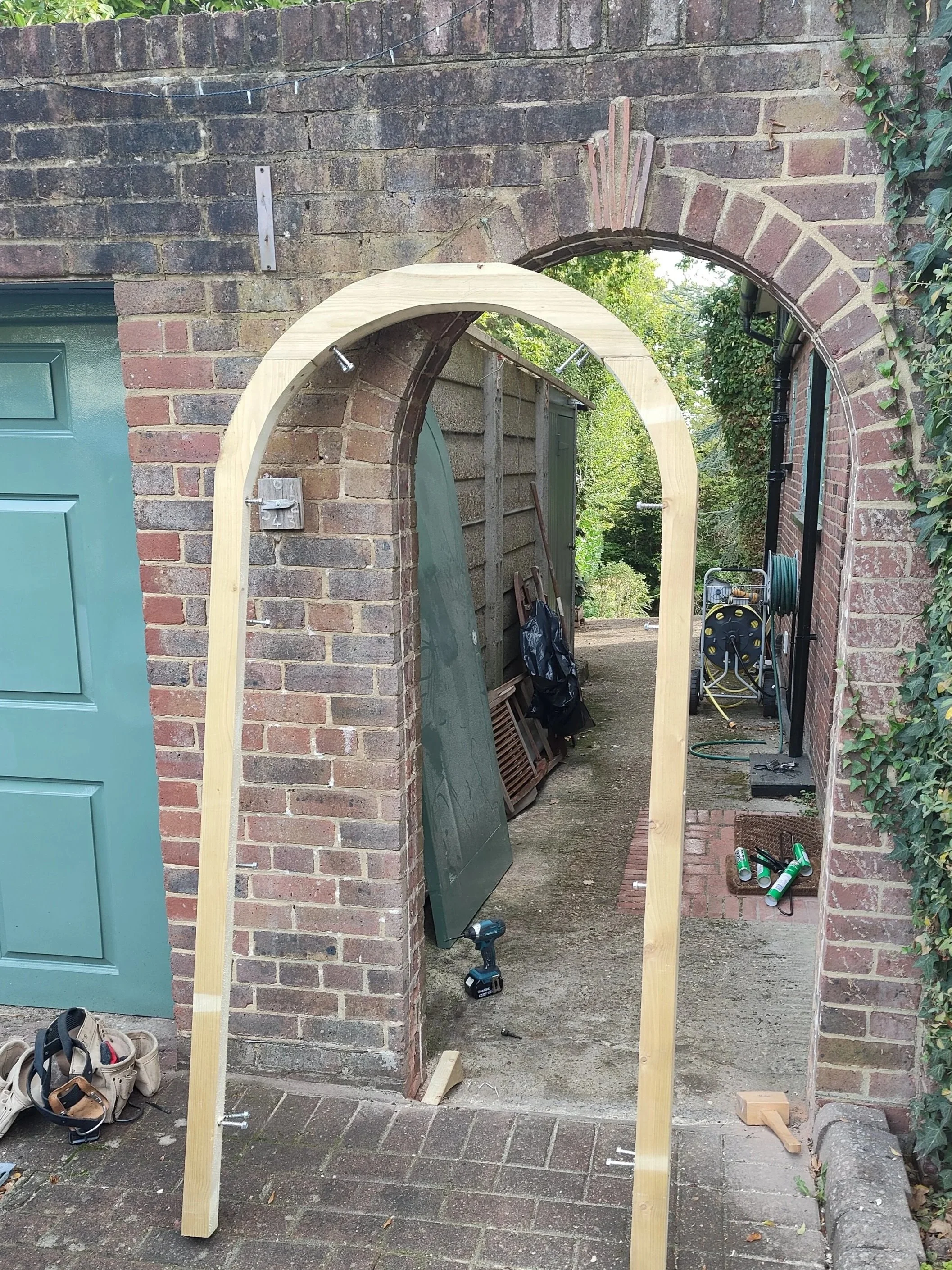 Bespoke carpentry repair of arched timber gate framework in South Croydon
