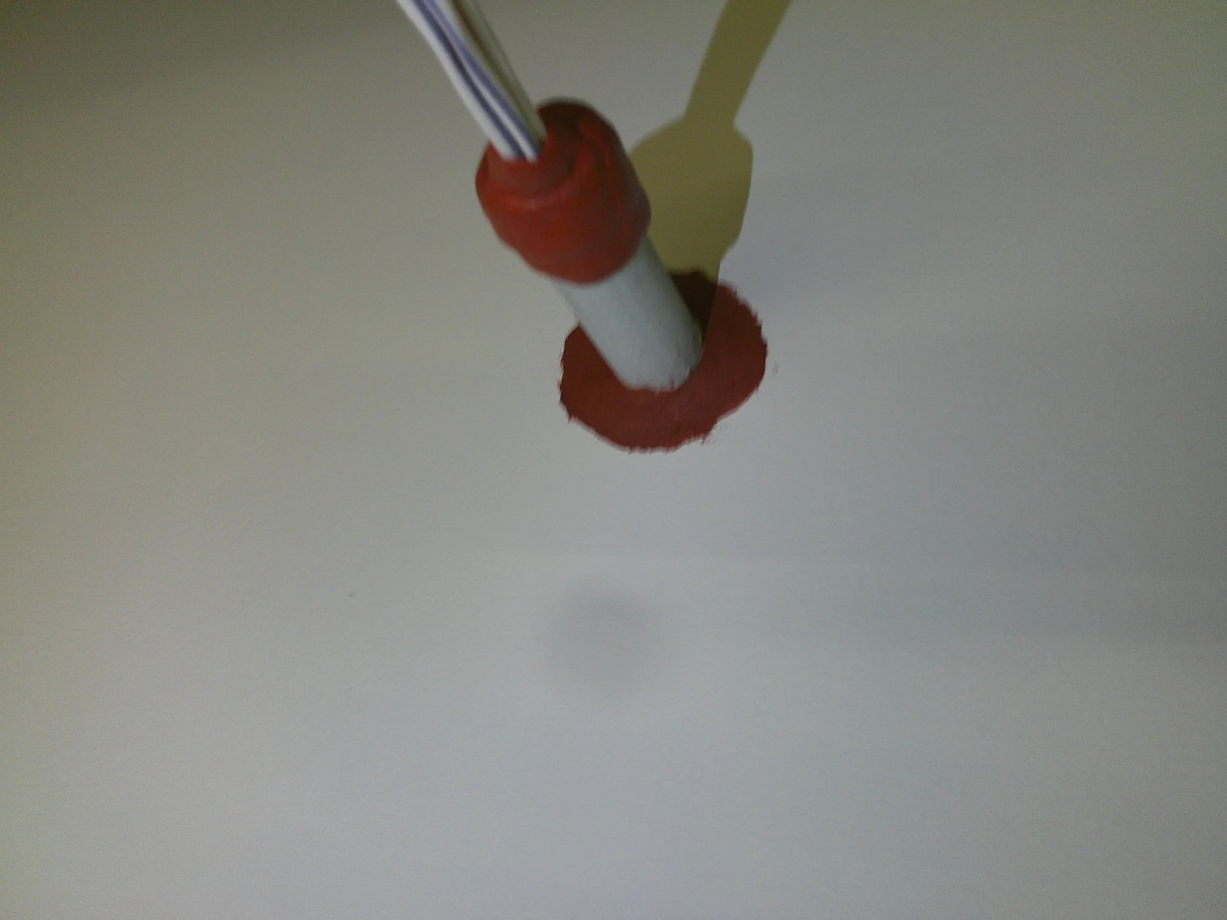 Close-up of a pipe recently fixed with Firestop caulk