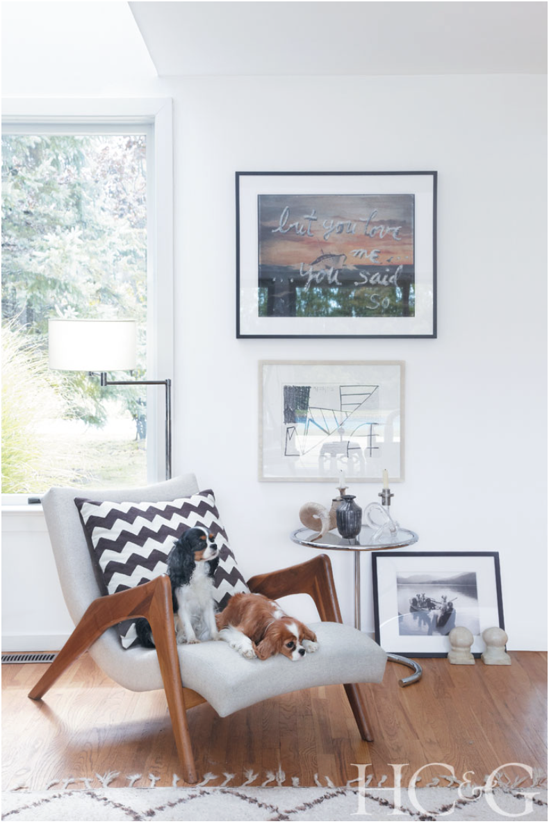 Photographs by Marili Forastieri; In Weinrib's living room, works by Rene Ricard and Carroll Dunham hang above an Eileen Gray side table; Daphne and Gemma perch on an adjacent mid-century-modern chair.