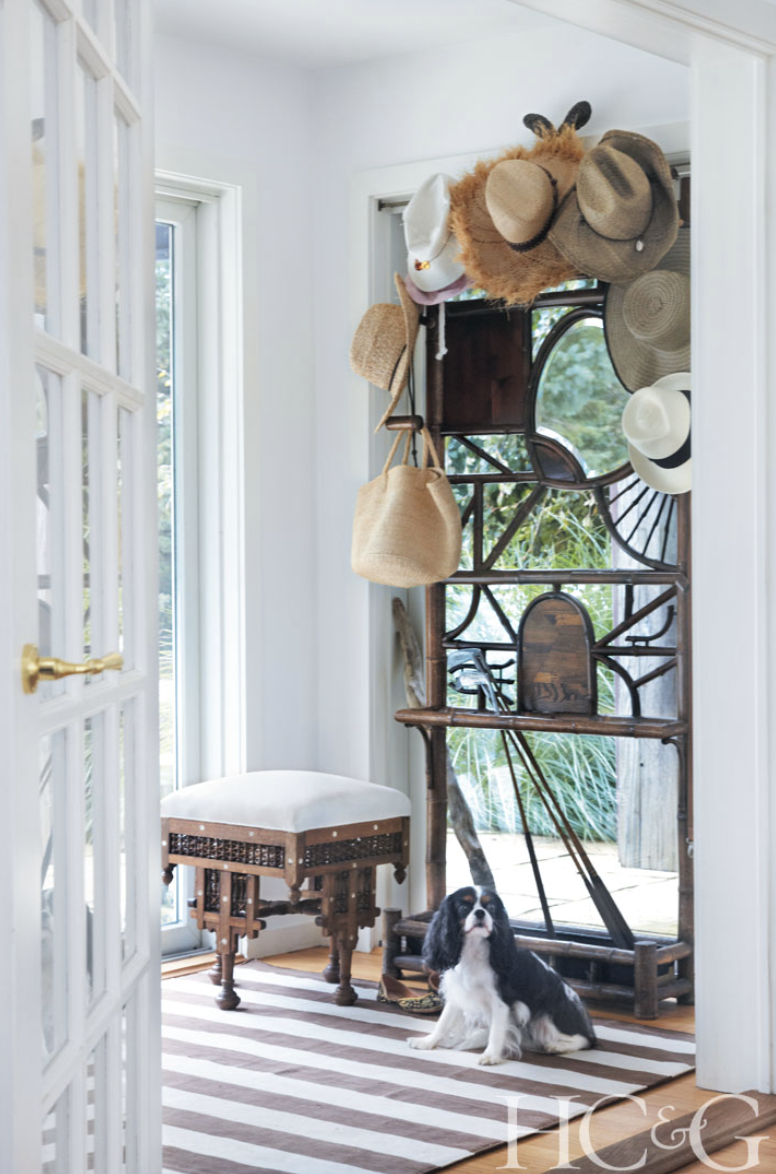 Photographs by Marili Forastieri; A mirrored French Art Deco hat stand from JED adds panache to the entry; the wood and inlaid-bone Indian bench dates from the 19th century.