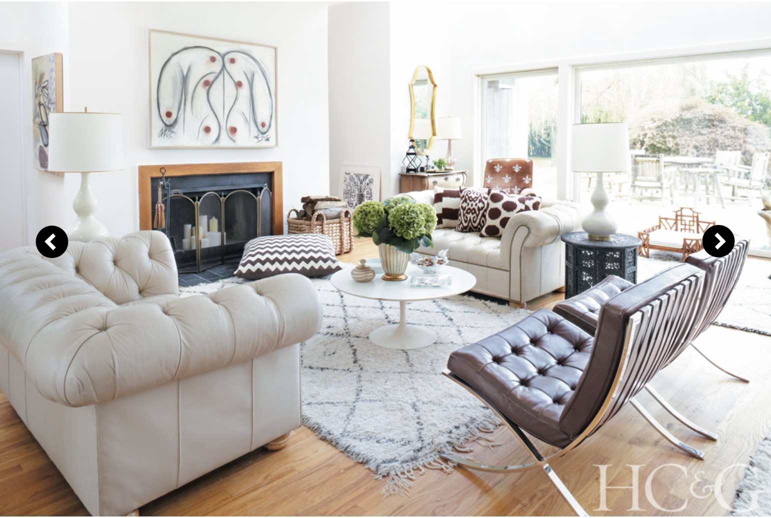 Photographs by Marili Forastieri; A pair of Chesterfield couches and two Barcelona chairs are arranged around an Eero Saarinen coffee table R.E. Steele. The painting above the mantel is by Keith Sonnier. 