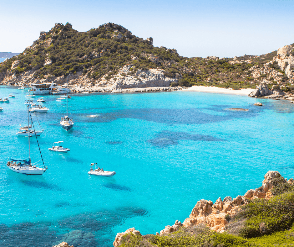 Sardinia beach with boats in the water