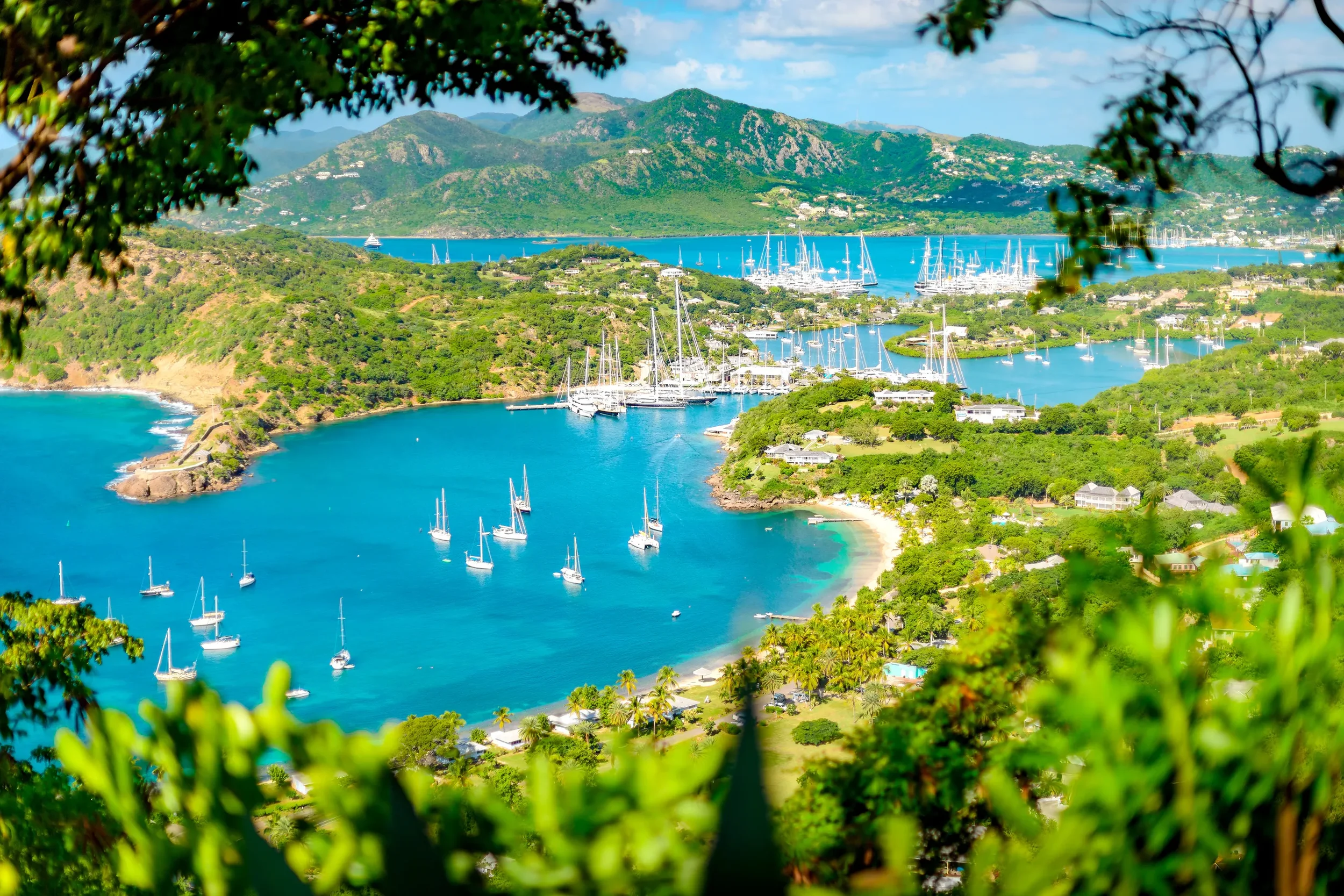tropical island vacation_Island with boats_collier travel collective