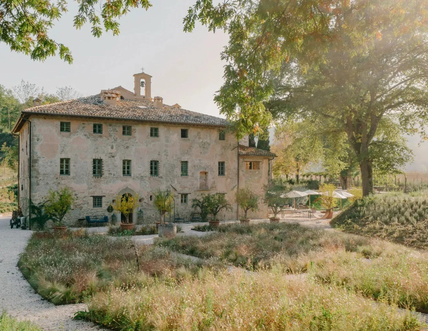Stone villa in the Italian countryside surrounded by gardens and trees