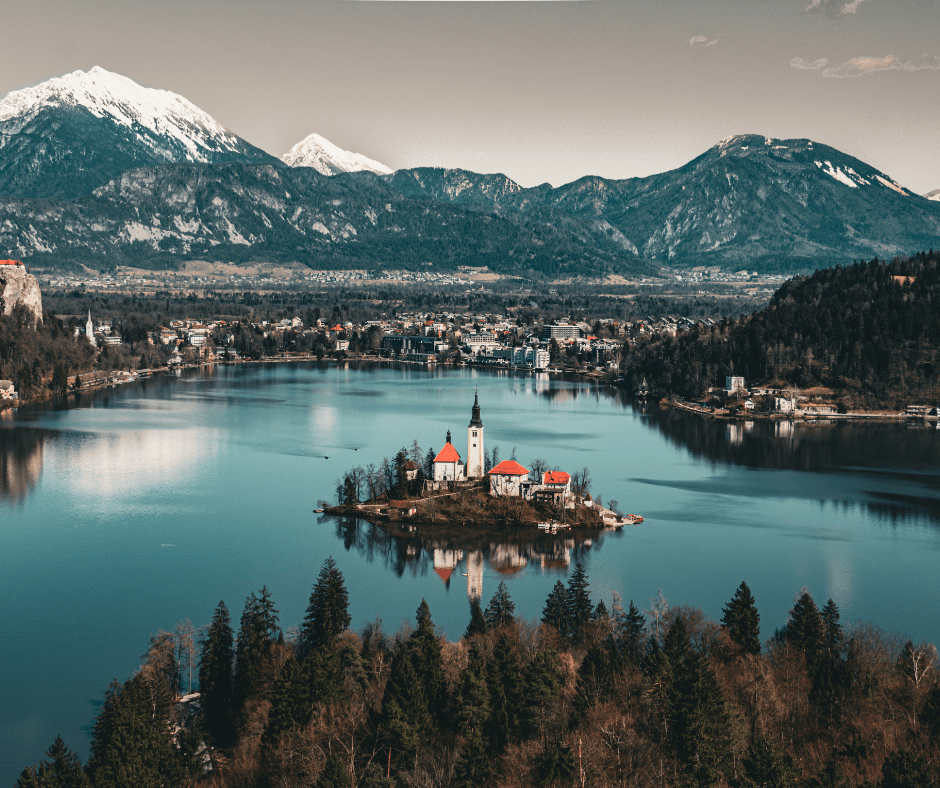 slovenia lake with town surrounding it