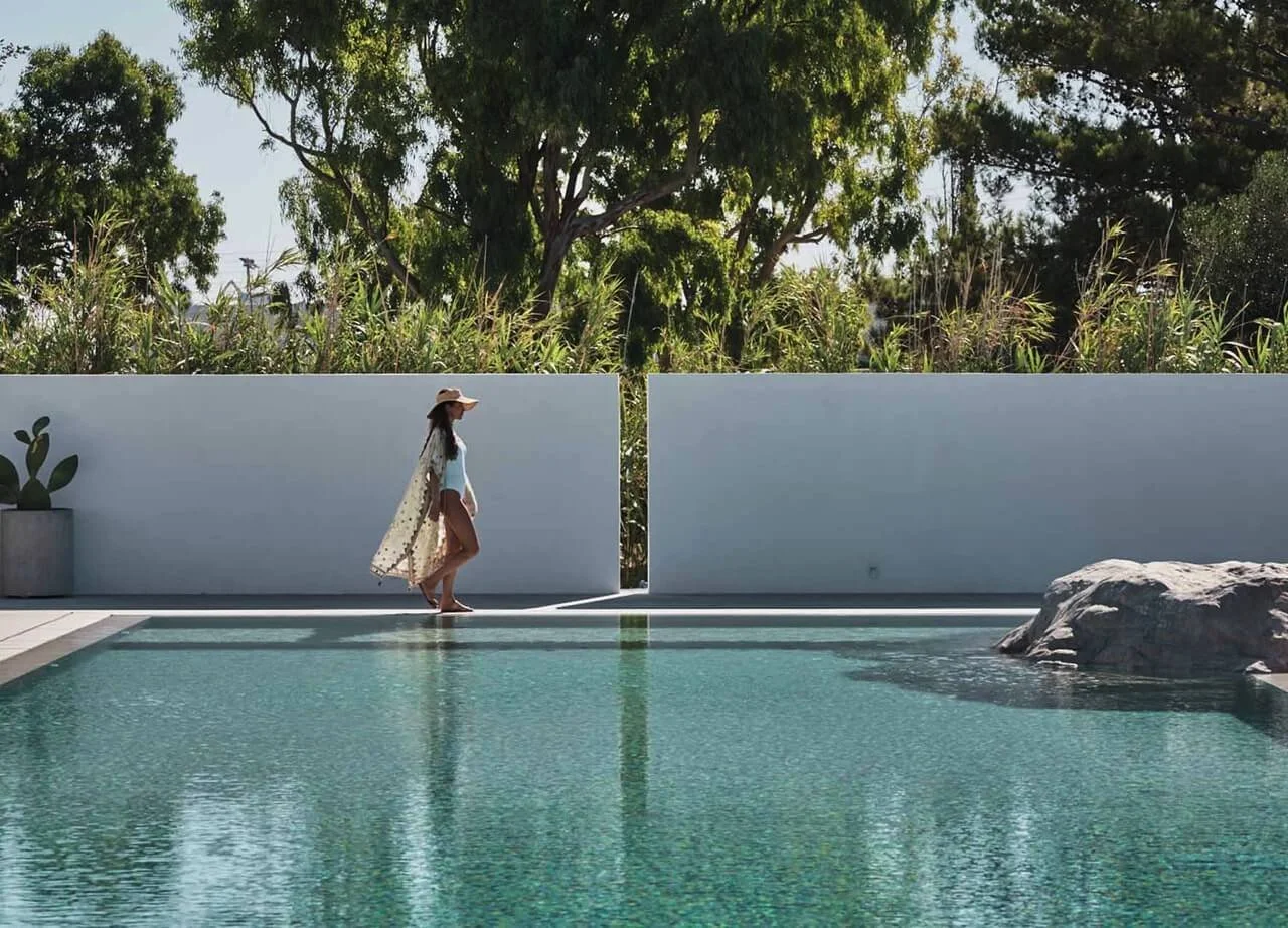 woman walking along a pool