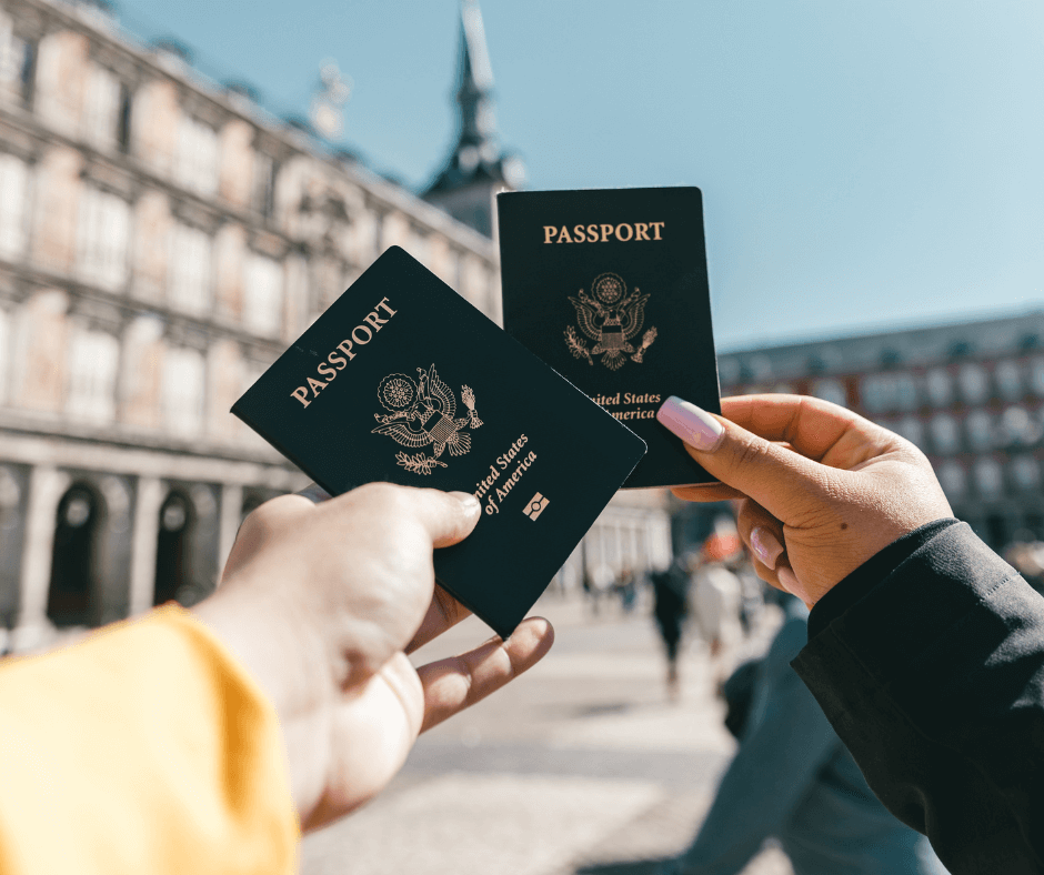 friends holding passports next to each other while traveling