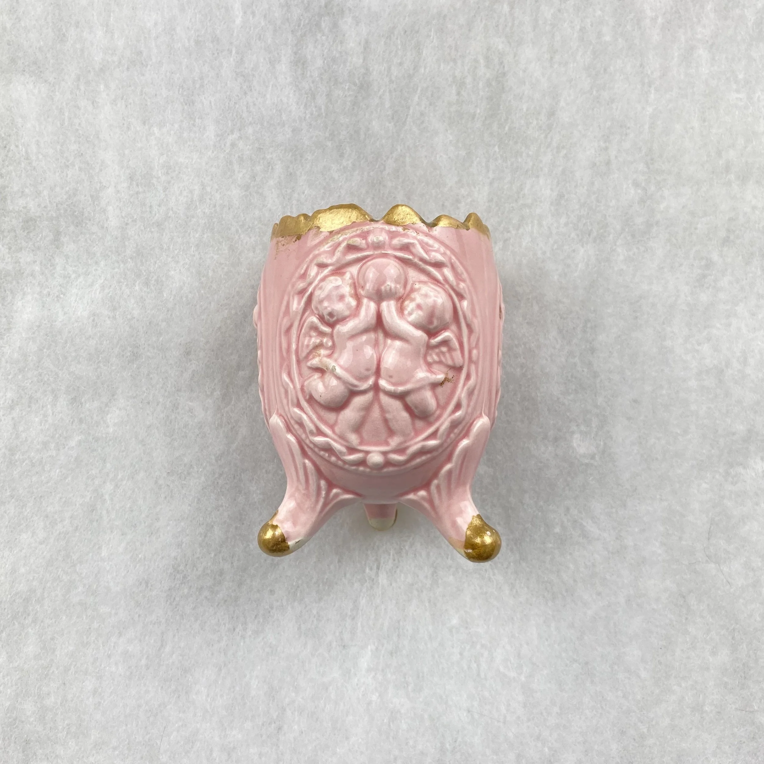   GAY object 086  Pink china egg cup with putti and gold details 