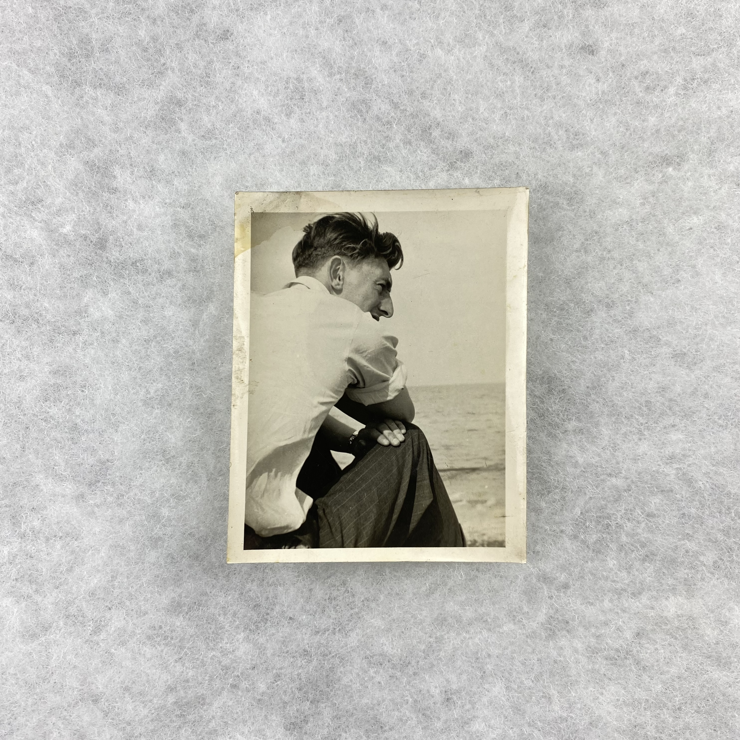   GAY object 073  Found photograph of a young man in profile at a beach 