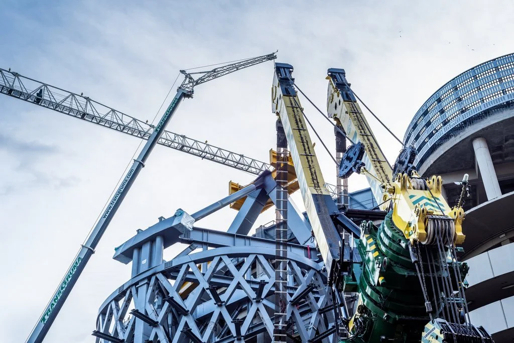 Bouwplaats met grote kraan en constructie van staal.
