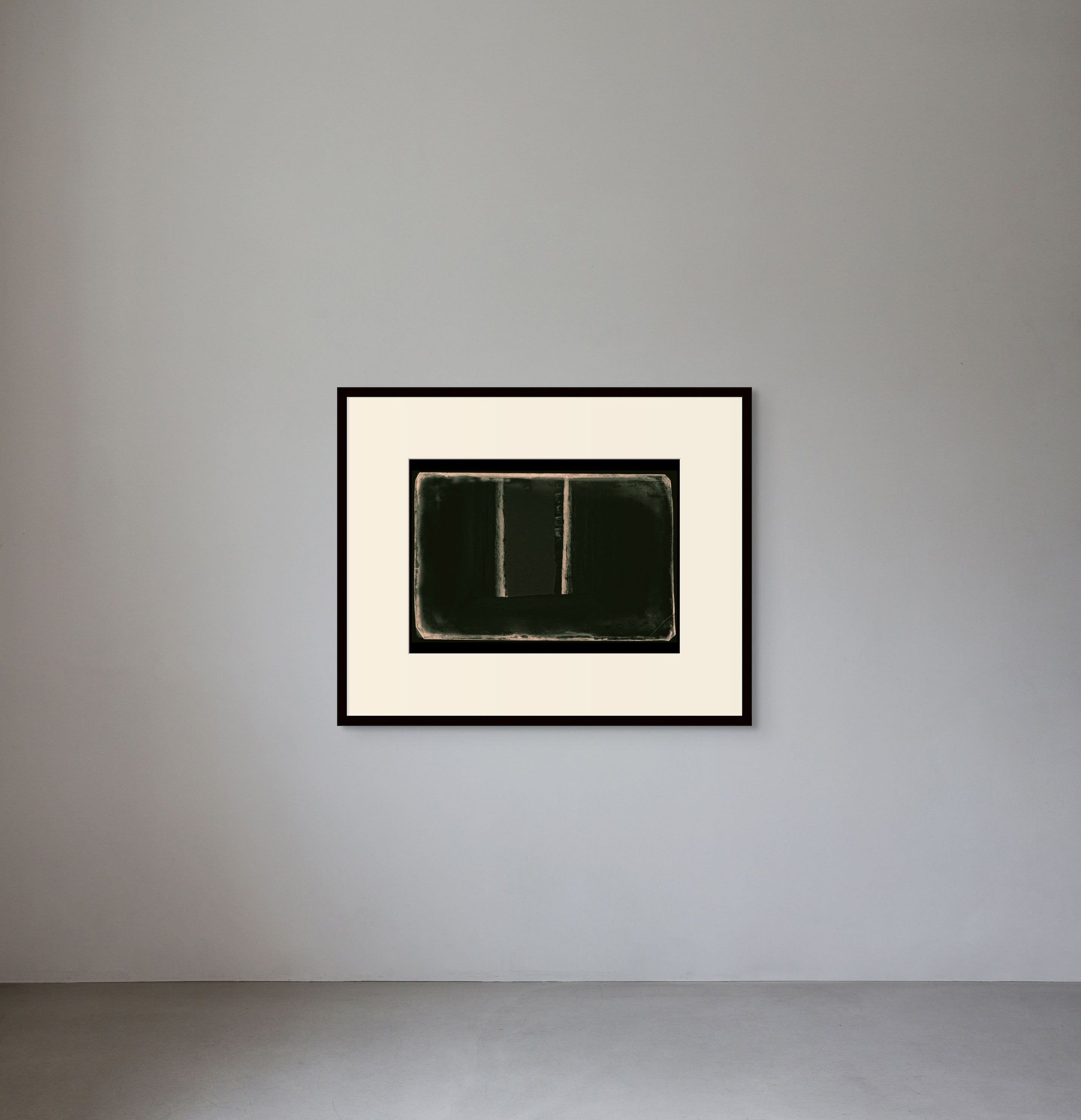 Minimalist art piece with dark green rectangular shape and two vertical lines, framed and displayed on a gray gallery wall.