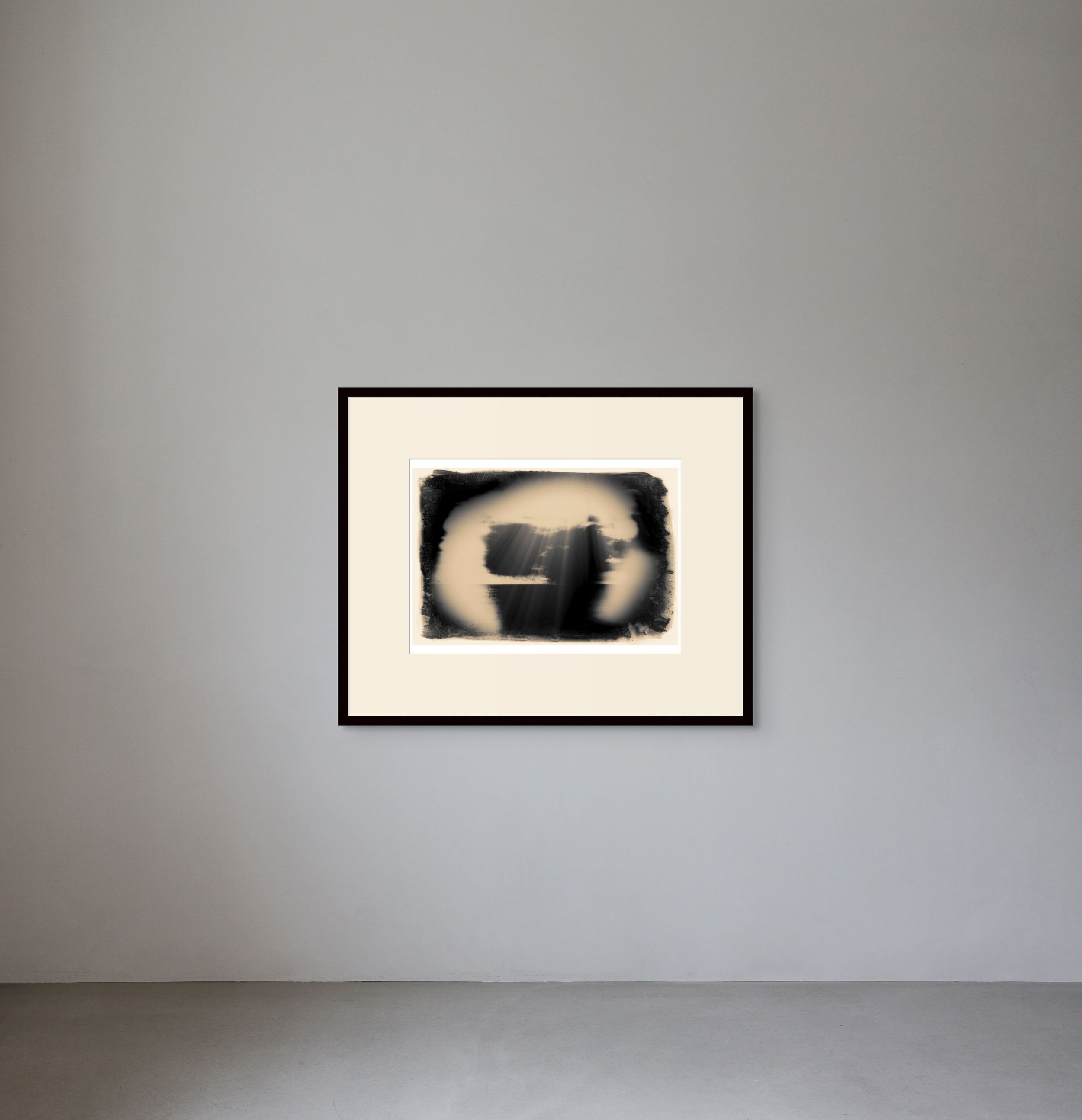Abstract black and white artwork framed on a gray gallery wall with a light background and subtle lighting.