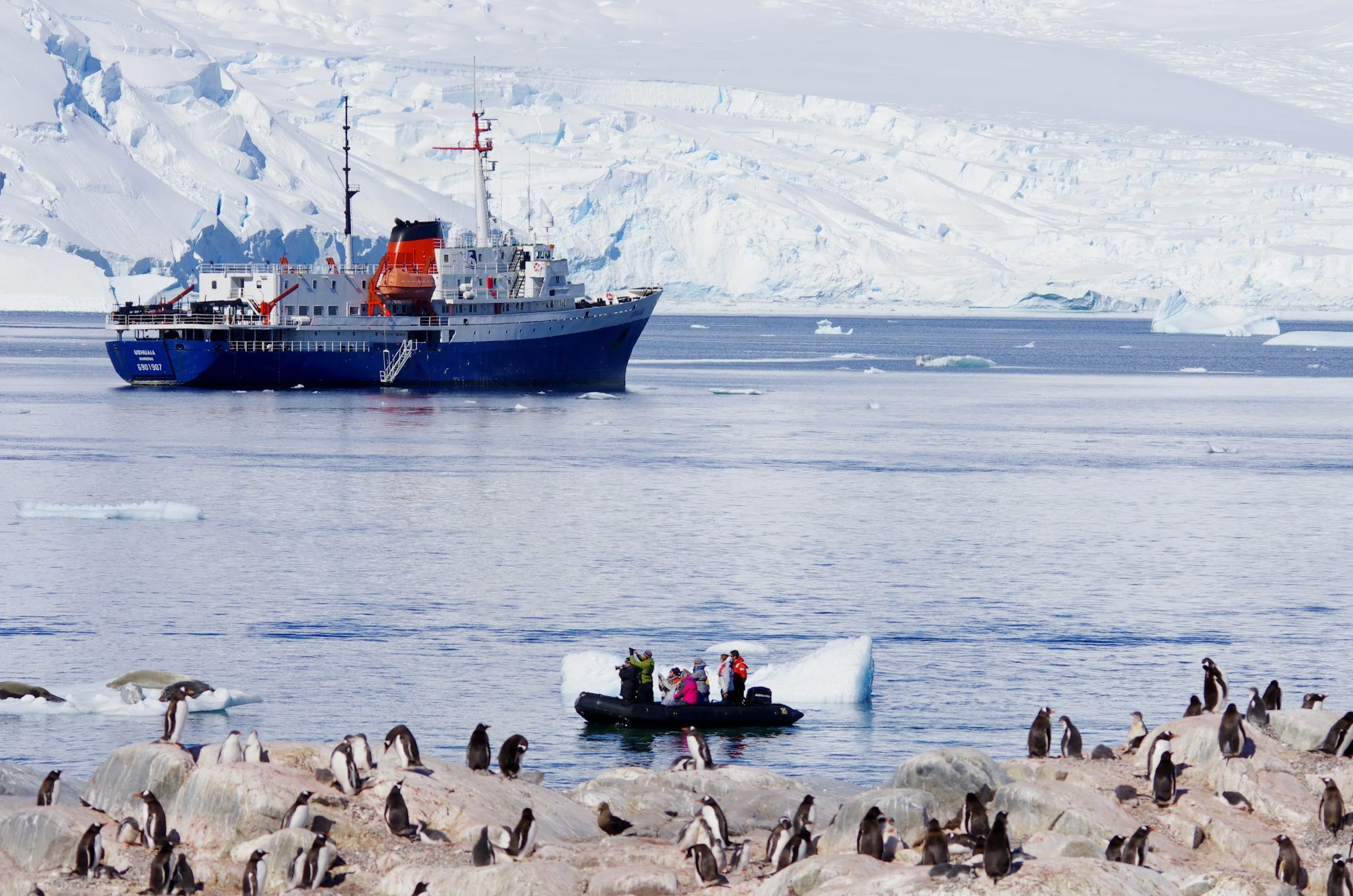 photo of small cruise ship in Antarctica near land