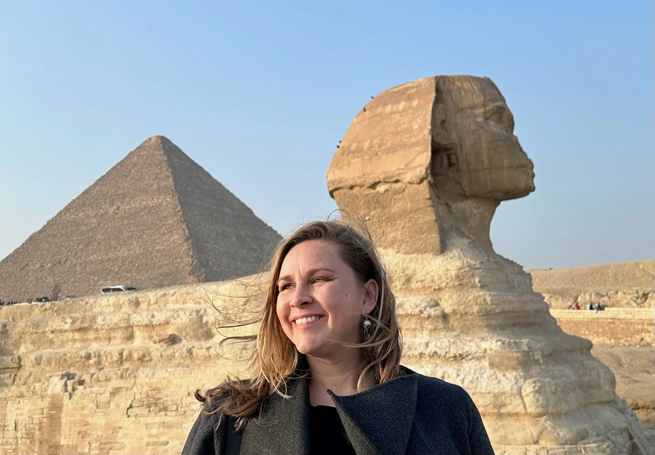 A woman poses in front of the sphinx in Egypt