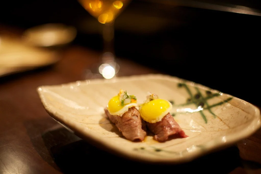 an artistic dish from Maido restaurant sits on a plate