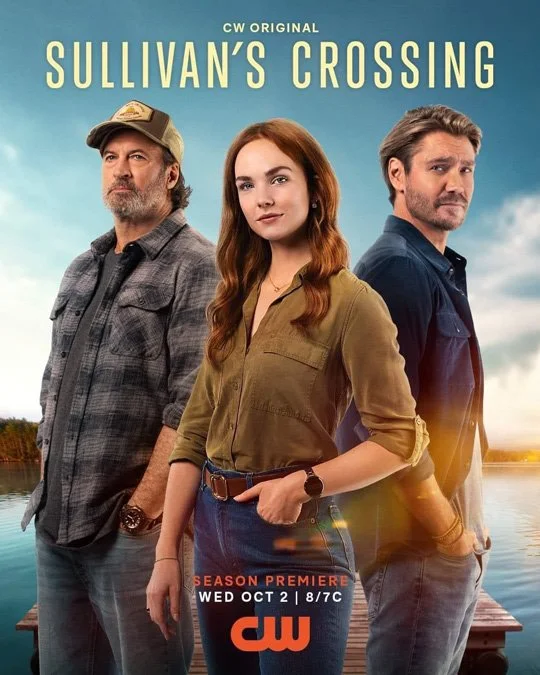 Promotional poster for the TV series 'Sullivan's Crossing' featuring three characters standing outdoors by a body of water during sunset, with the show's title and premiere date.