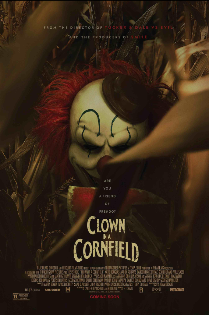 A horror movie poster for 'Clown in a Cornfield,' featuring a sinister clown mask with red hair, a dark paint smile, and creepy eyes, set against a cornfield background.