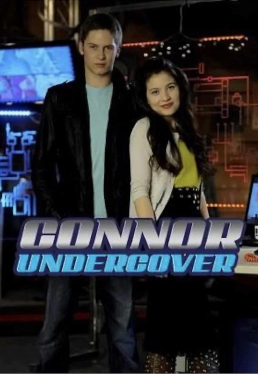 Two young people standing behind a sign that says "Honour Undercover" in front of a display with digital maps and circuitry graphics.