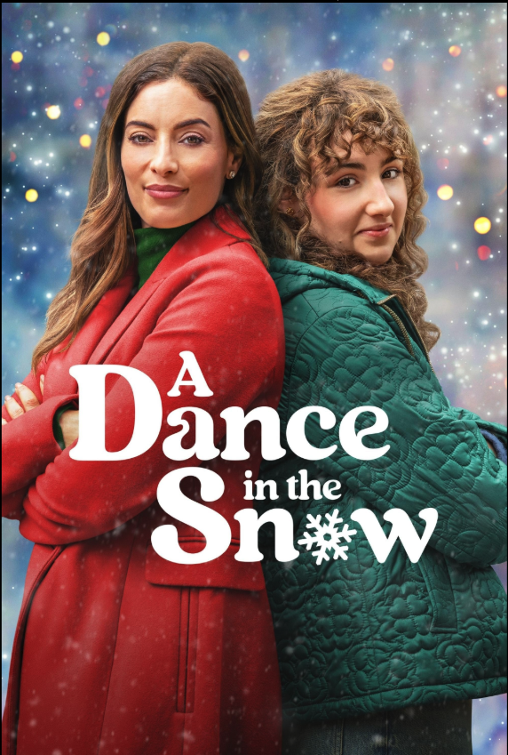 Two women standing back to back with arms crossed, posing outdoors during winter snowfall against a holiday-themed background. The woman on the left has brown hair and is wearing a red coat with a green scarf. The woman on the right has curly light b