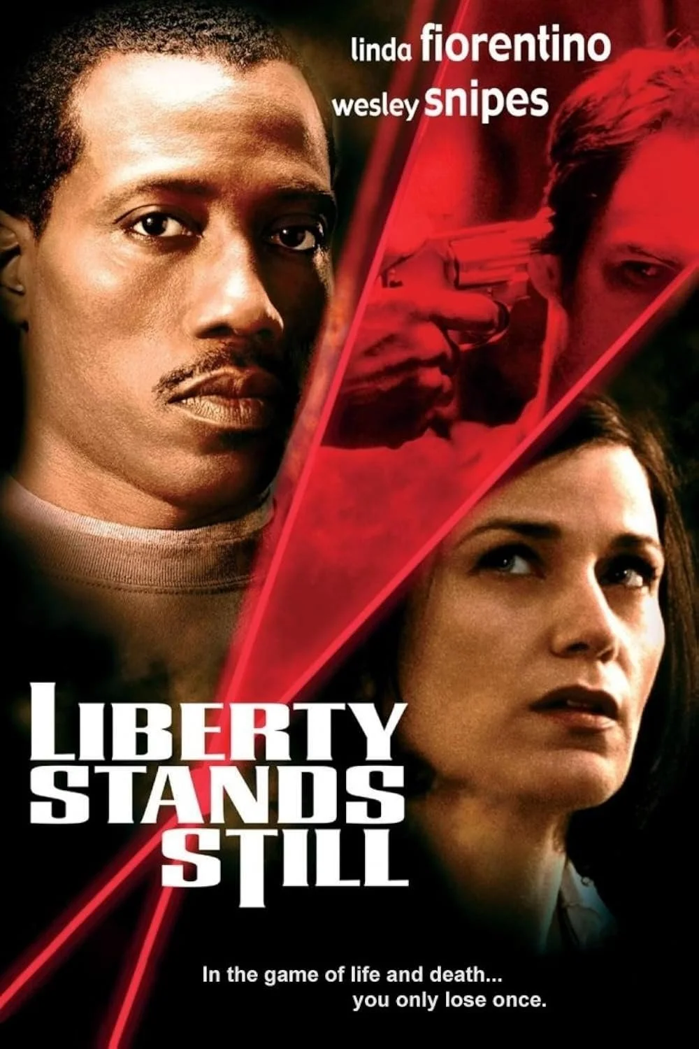 Movie poster for 'Liberty Stands Still' featuring close-up images of a man and a woman, with a red-tinted scene of a gun pointed at the man and woman in the background. The title is in bold white, black, and red text, and the tagline reads, 'In the g