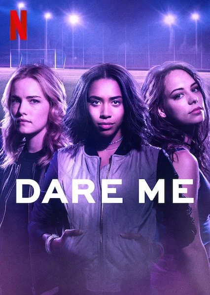Three teenage girls with serious expressions standing in front of a sports field at night, with a neon purple and blue color tone, promoting the Netflix series "Dare Me."