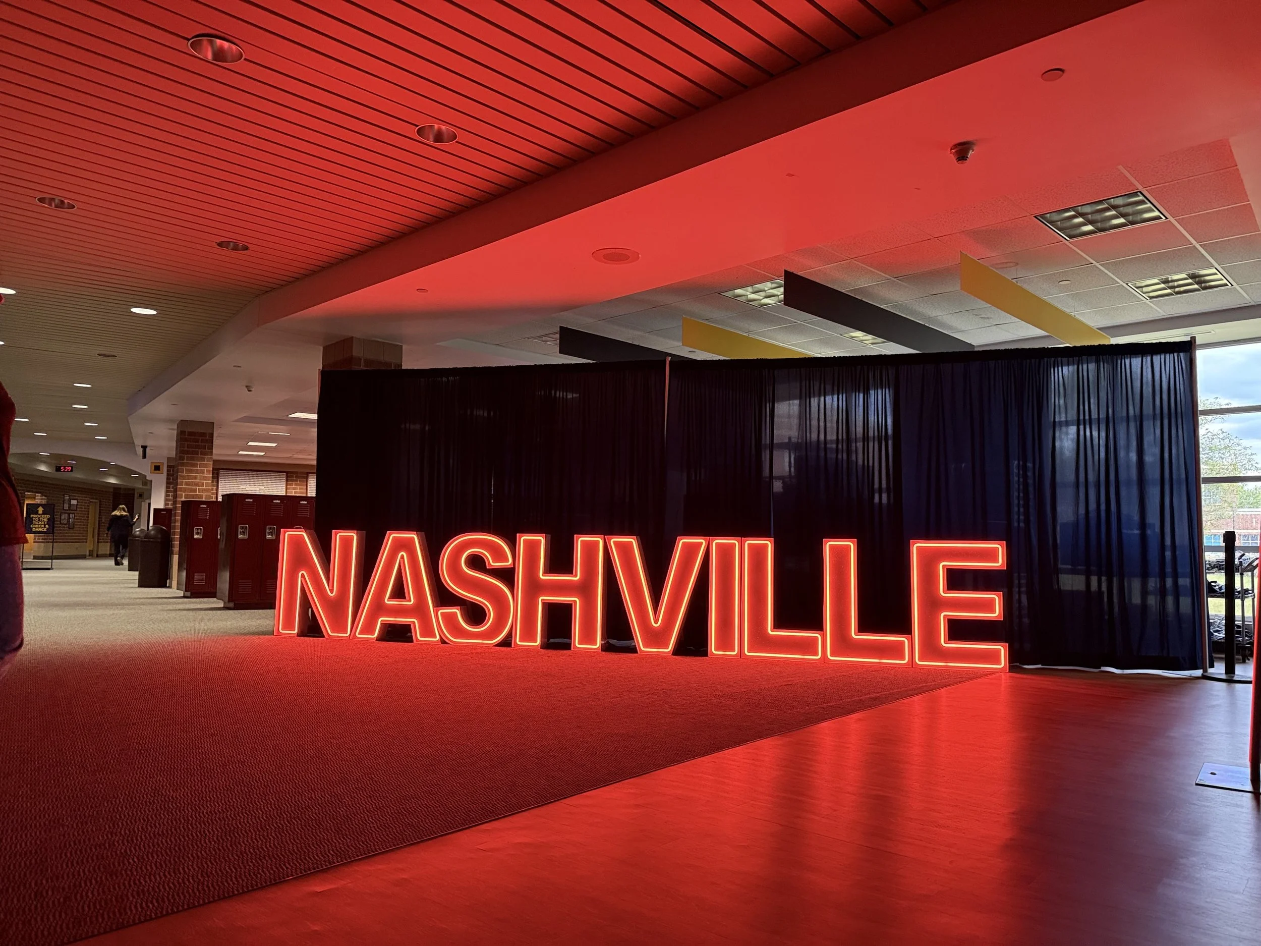 Neon sign spelling 'NASHVILLE' illuminated in red LED Marquee letters for Homecoming theme 