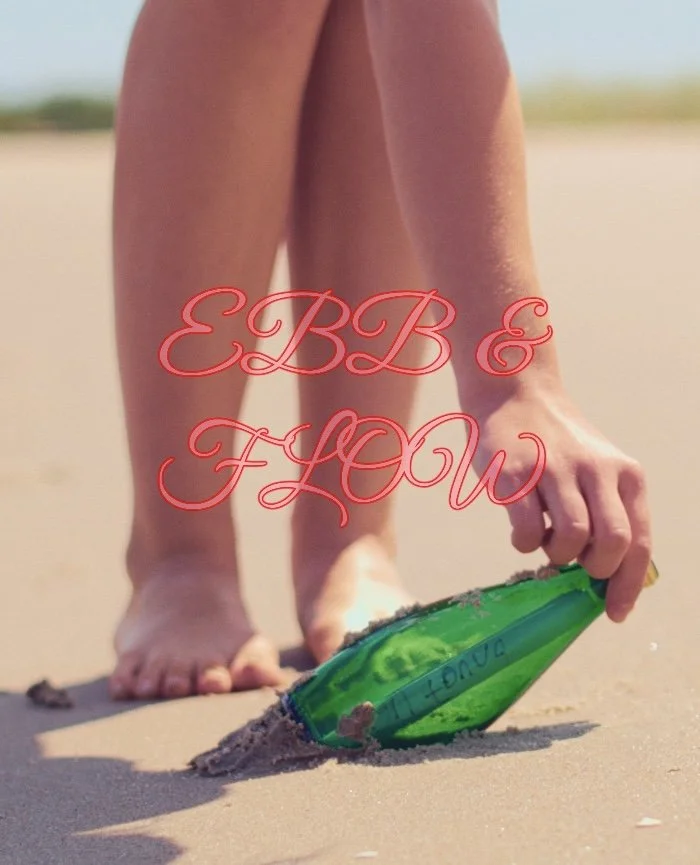 Child playing with a green plastic shovel on the beach during daytime