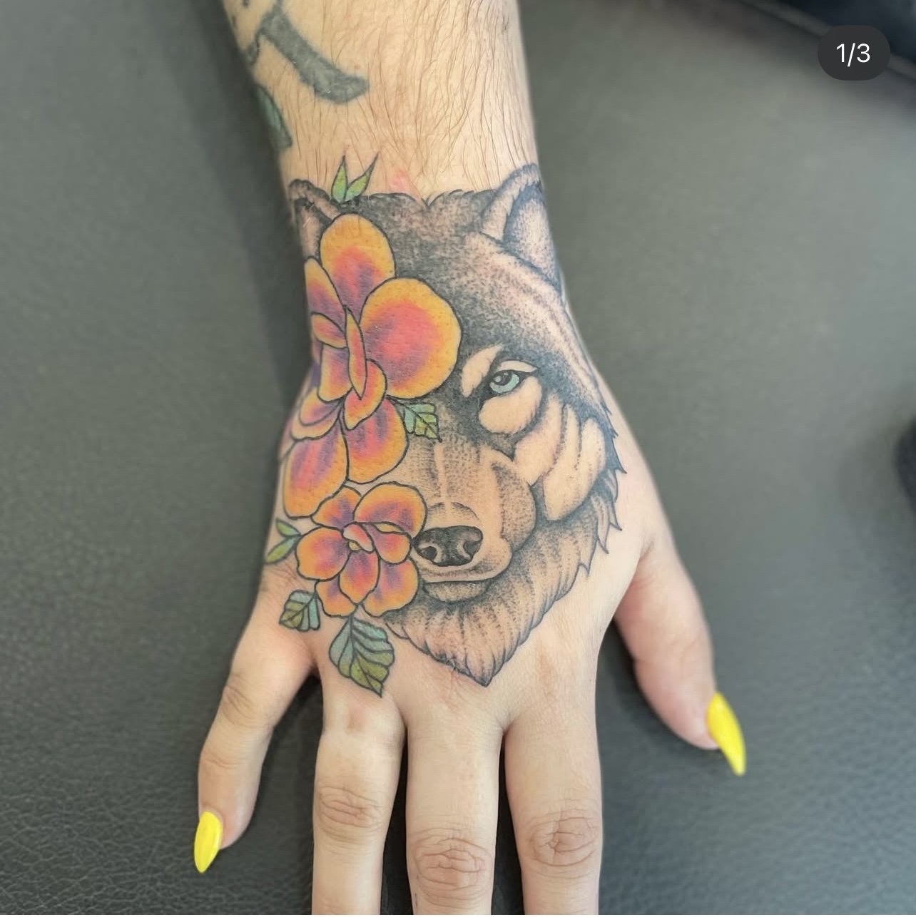 animal tattoo of wolf and floral hand piece for women Jocelyn Groff