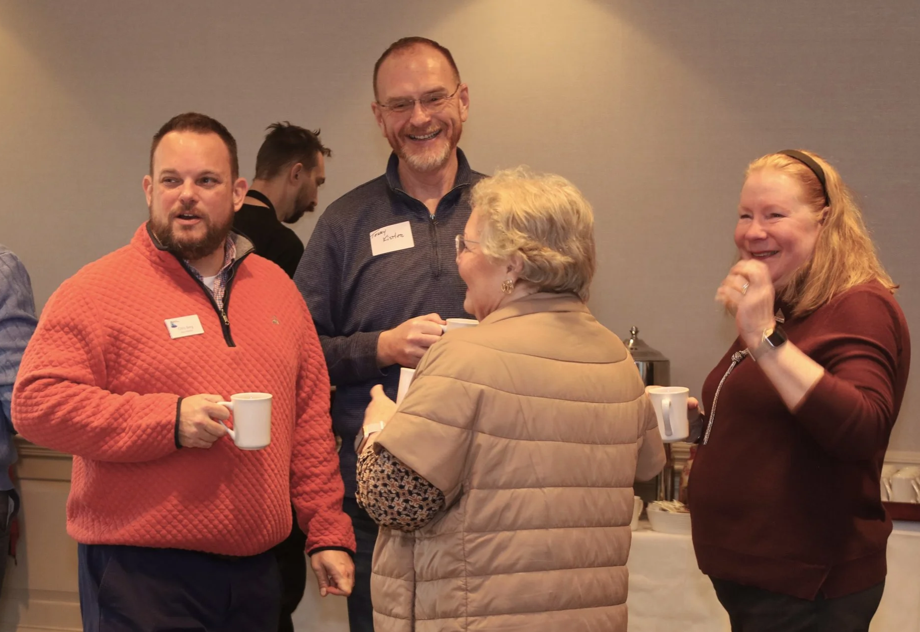Past board president and current board member Chris Berg and Terry Kistler talk with board member Kim Mason and Sandra Humphrey.