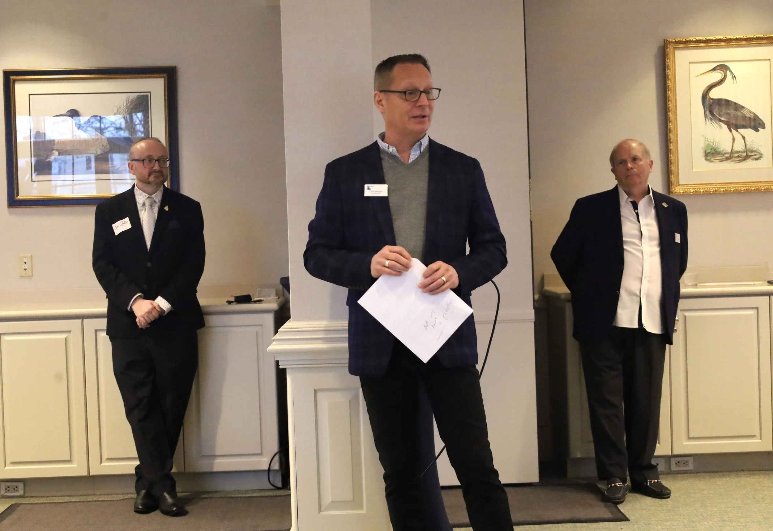 Capital Campaign Vice Chair Chris Beagle (center) addresses the room, with Managing Director Joe Gfaller (left) and Capital Campaign Chair Rick Perry (right)