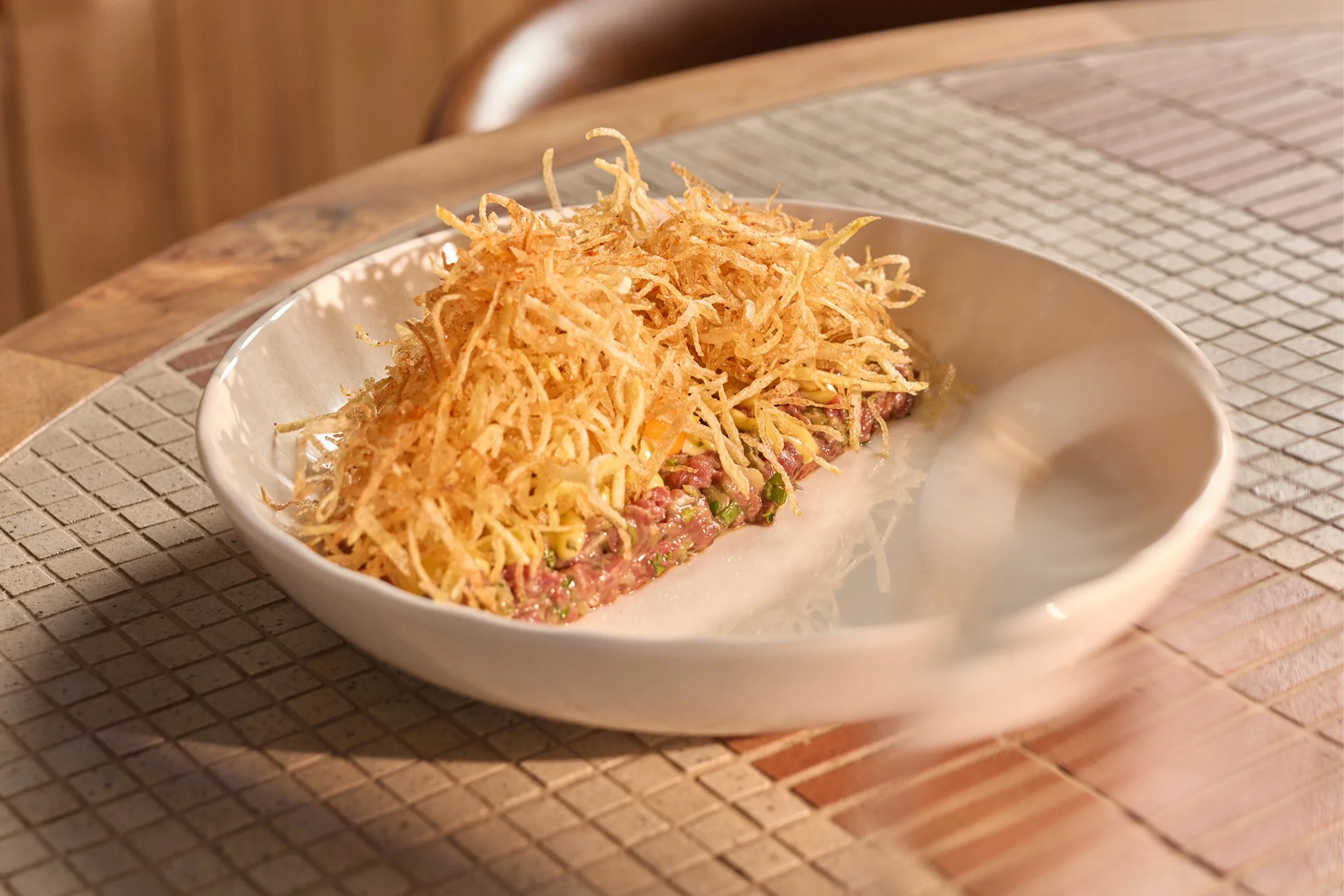 Steak tartare topped with crispy shoestring potatoes at La Zeppa in Freemans Bay