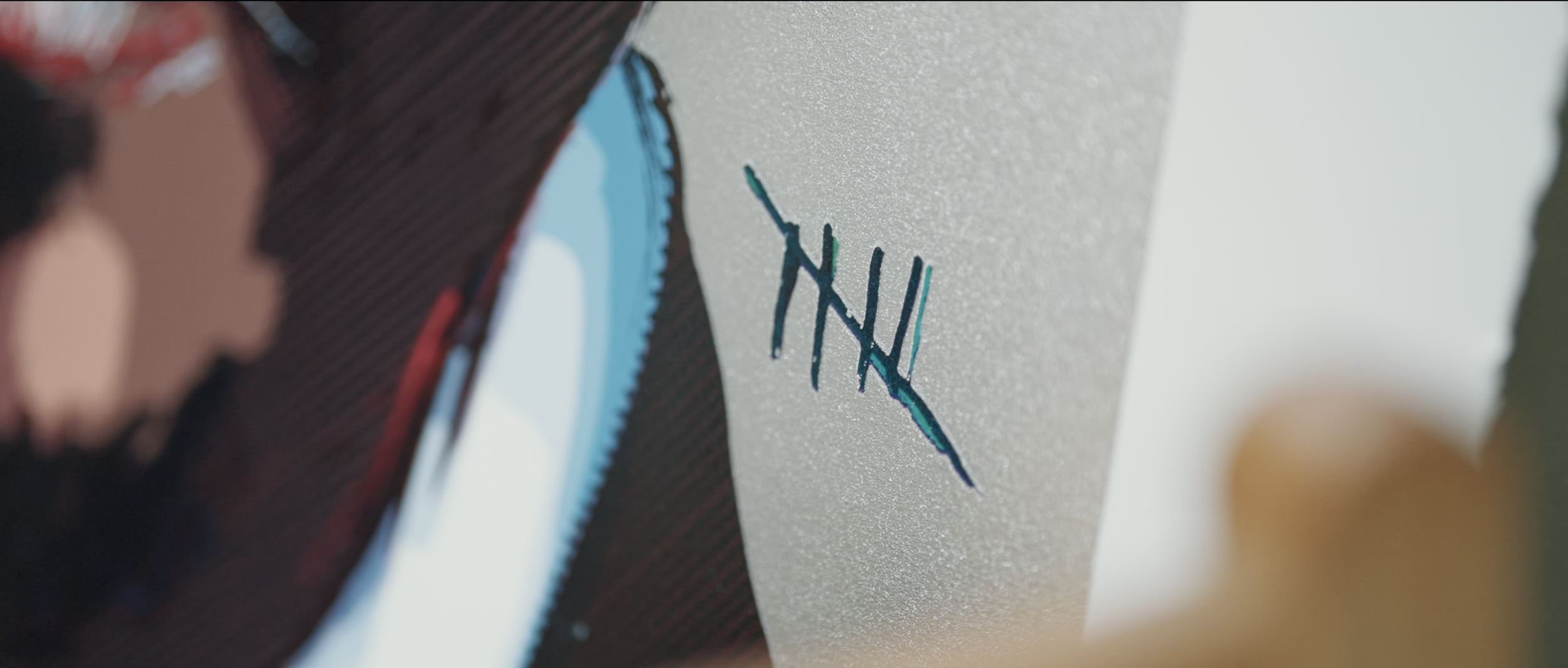 Close-up of a textured white surface with a logo consisting of stylized, overlapping blue and black letters.