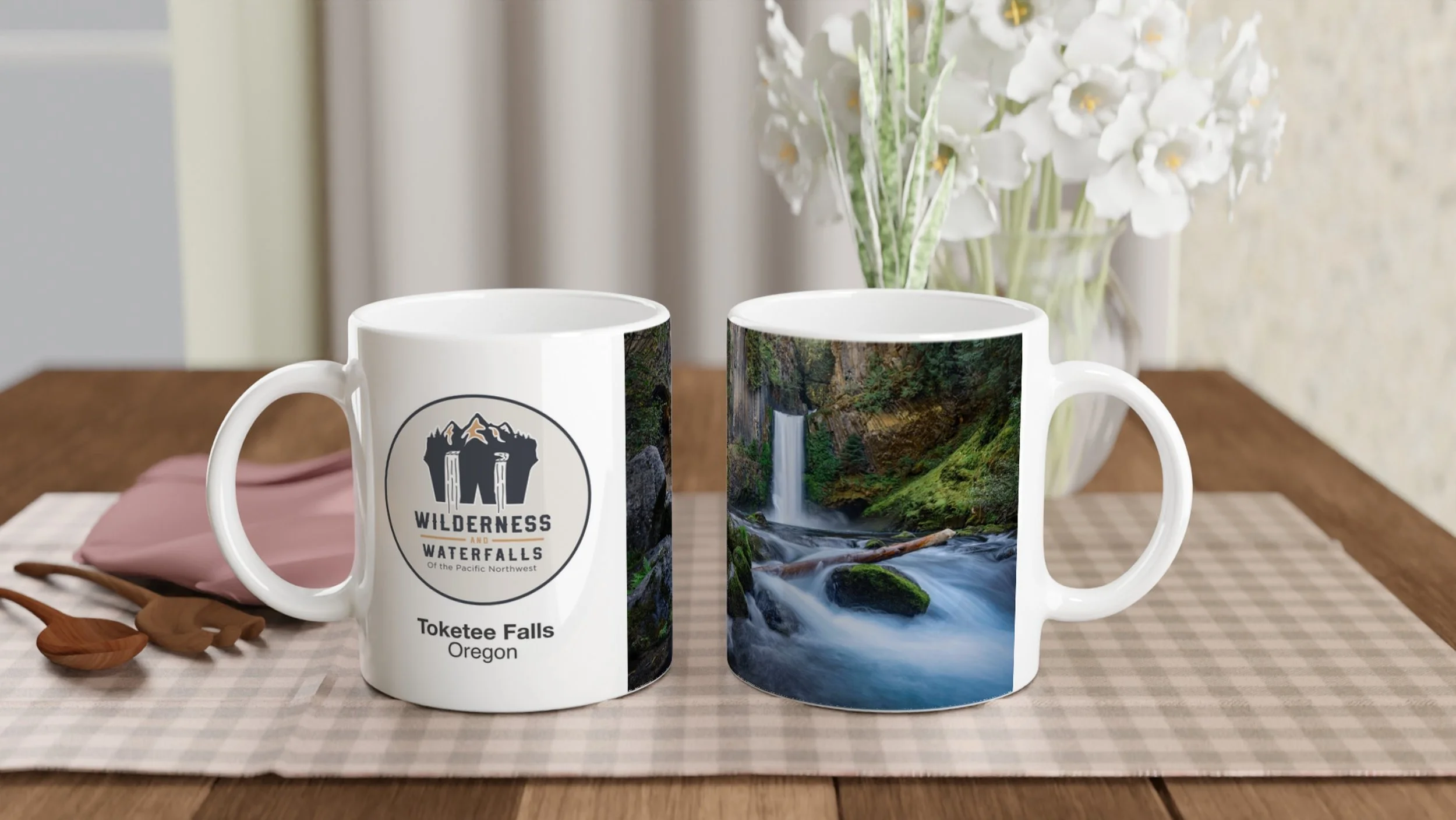 Two views of the same Toketee Falls photo mug on a dining table, showing the logo side and waterfall side.