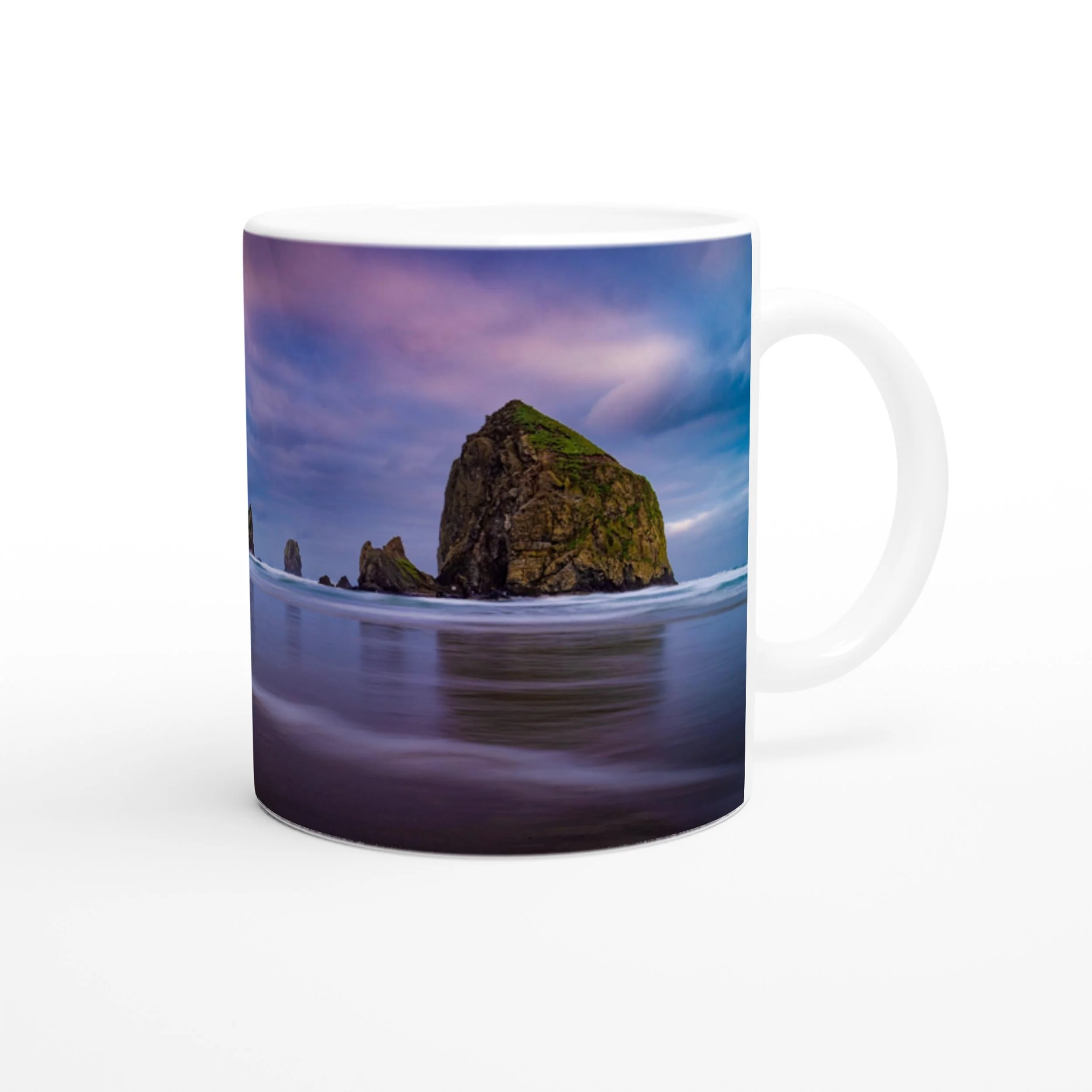 Haystack Rock photo side of the white ceramic mug on a white background.