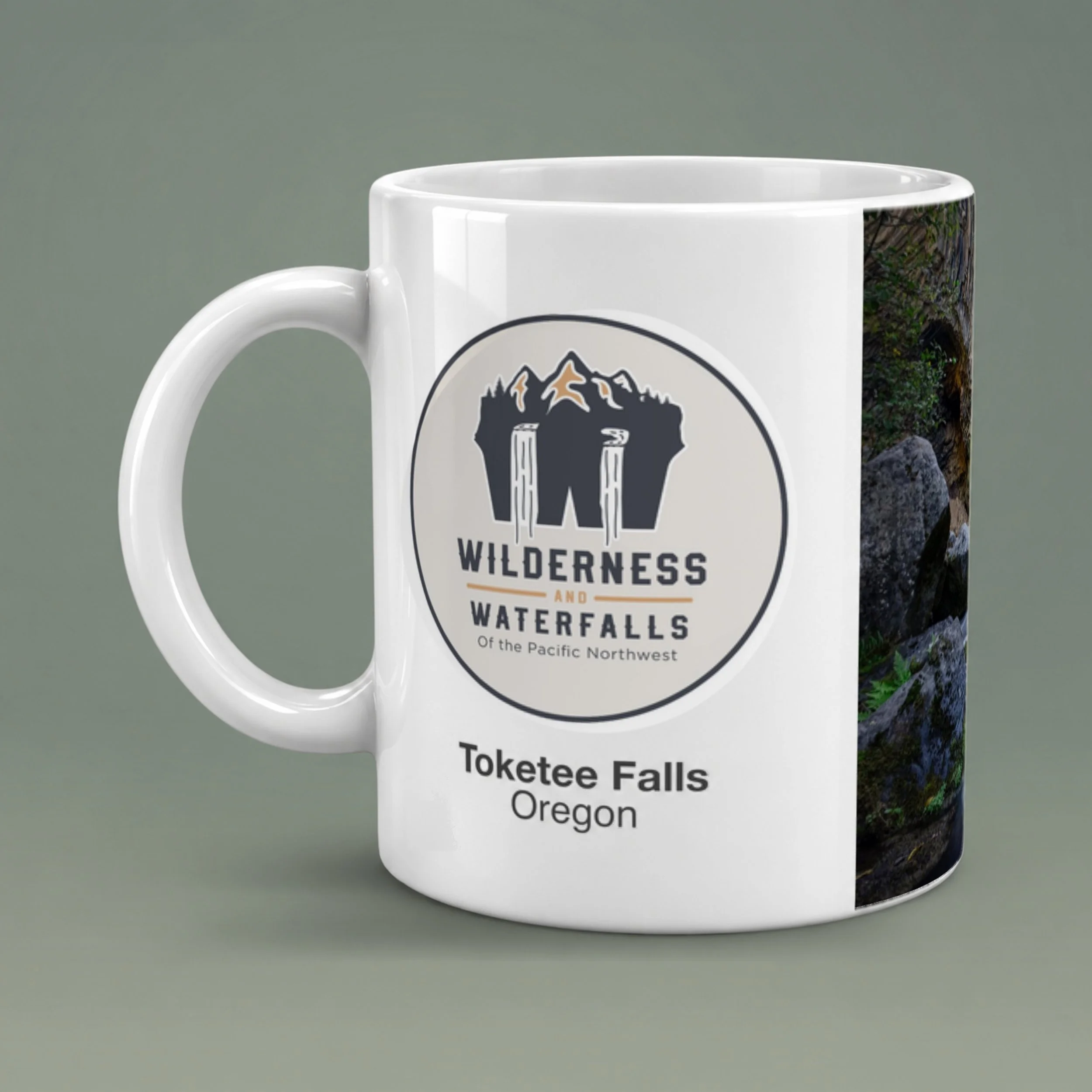 White ceramic mug with the Wilderness & Waterfalls logo and Toketee Falls, Oregon text, showing glossy glaze and a rounded handle.