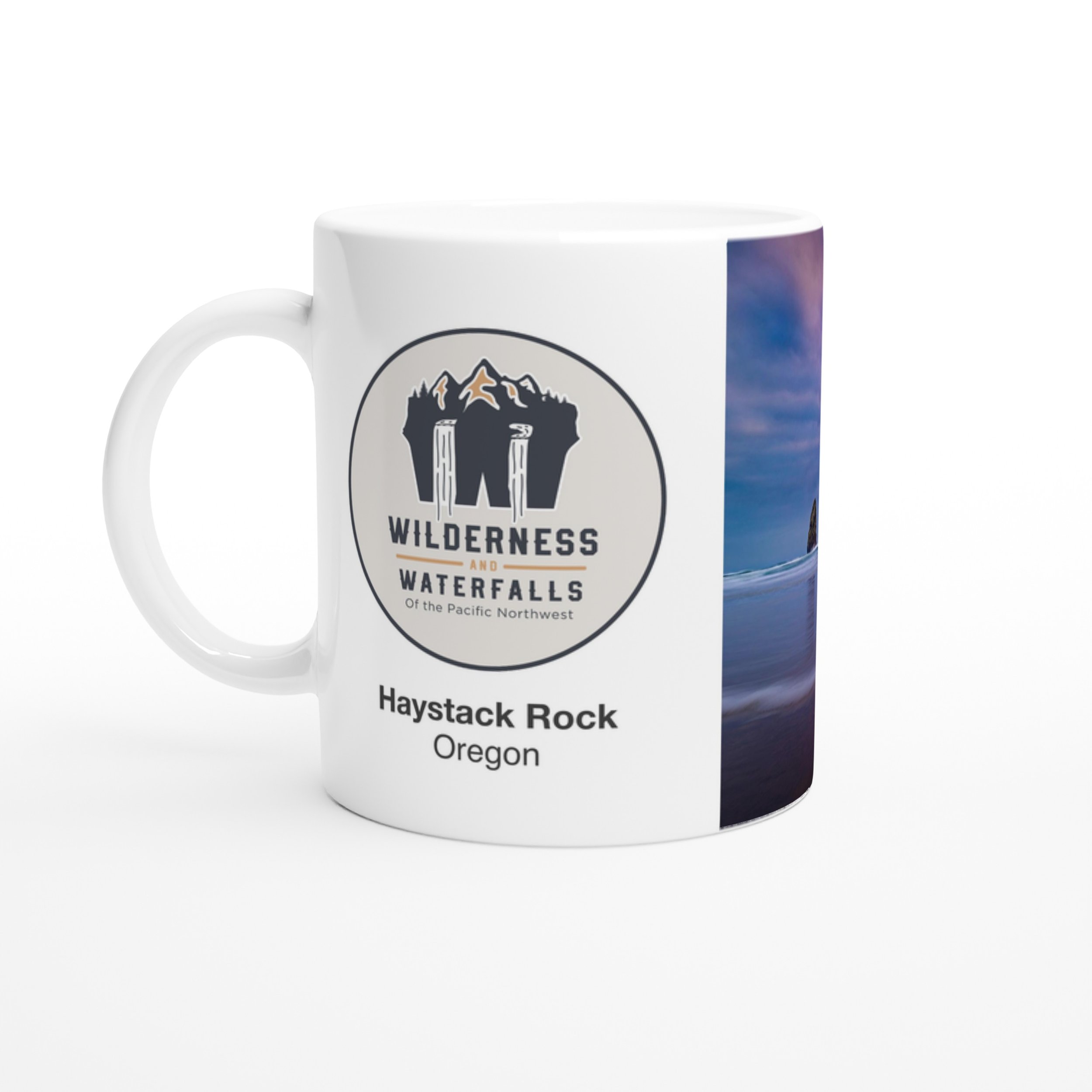 Logo side of the white Haystack Rock, Oregon ceramic mug on a white background.