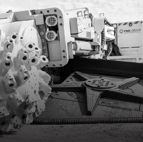 Industrial mining machine with rotating drill head for tunneling and excavation.