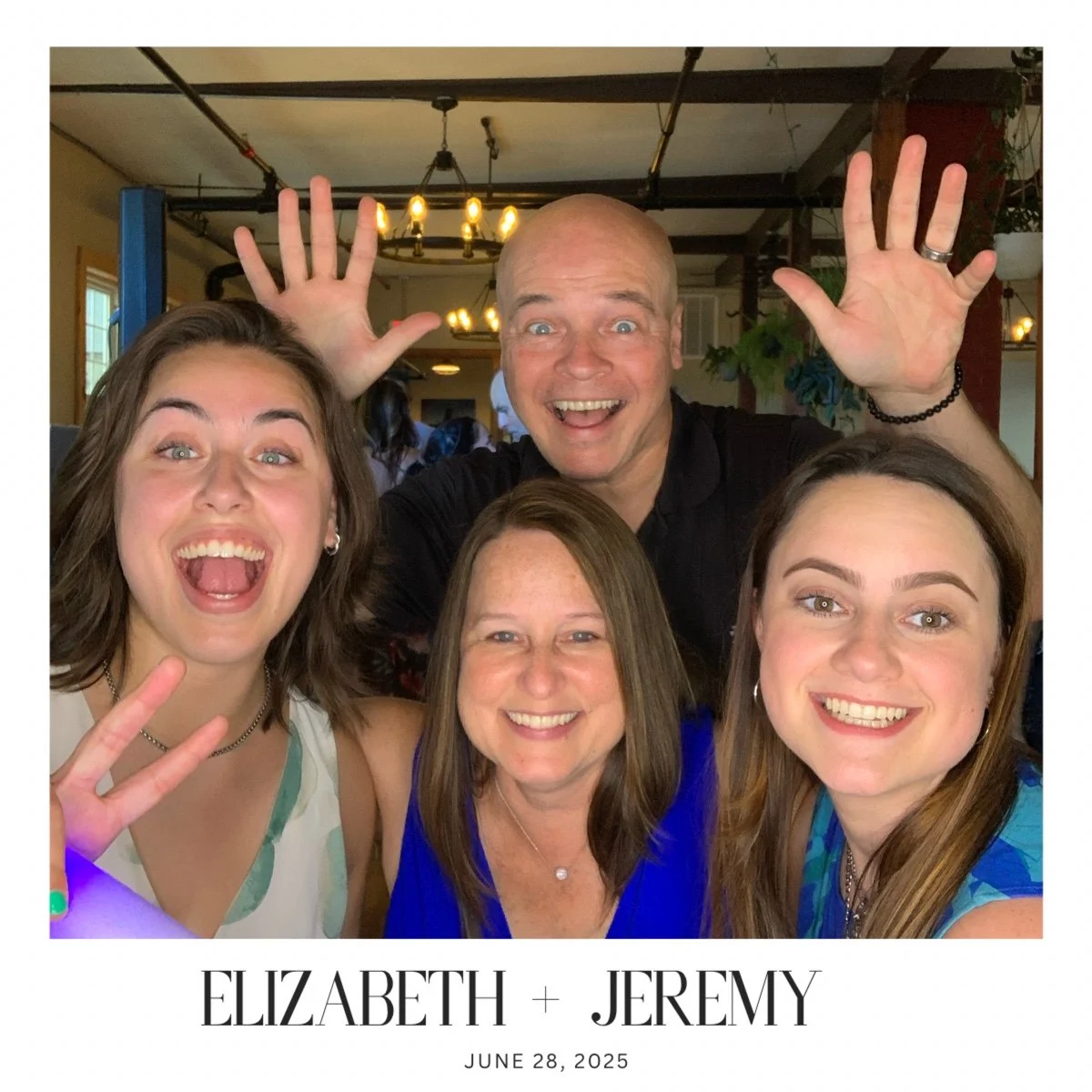 A group of five joyful people smiling and making peace signs at a celebration event for Elizabeth and Jeremy on June 28, 2025.