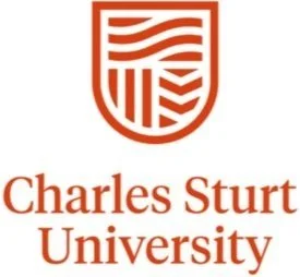 Charles Sturt University logo featuring a shield with wavy lines and geometric patterns above the university name.