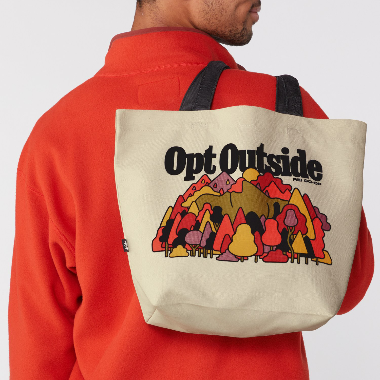 Illustration of a mountain forest with trees in various colors, and the text 'Opt Outside REI Co-op' in bold black letters.