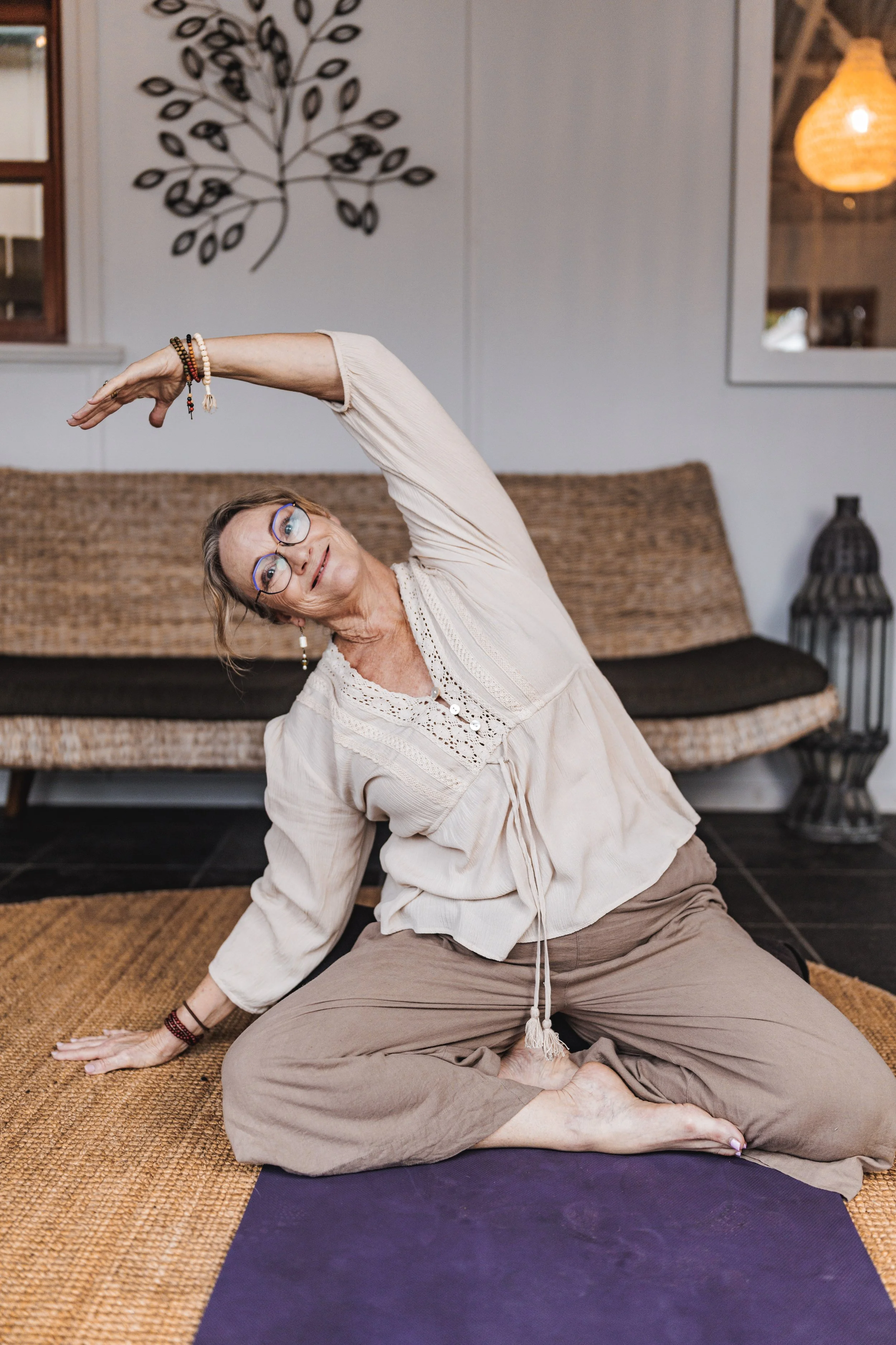 shannon in a yoga pose smiling at the camera