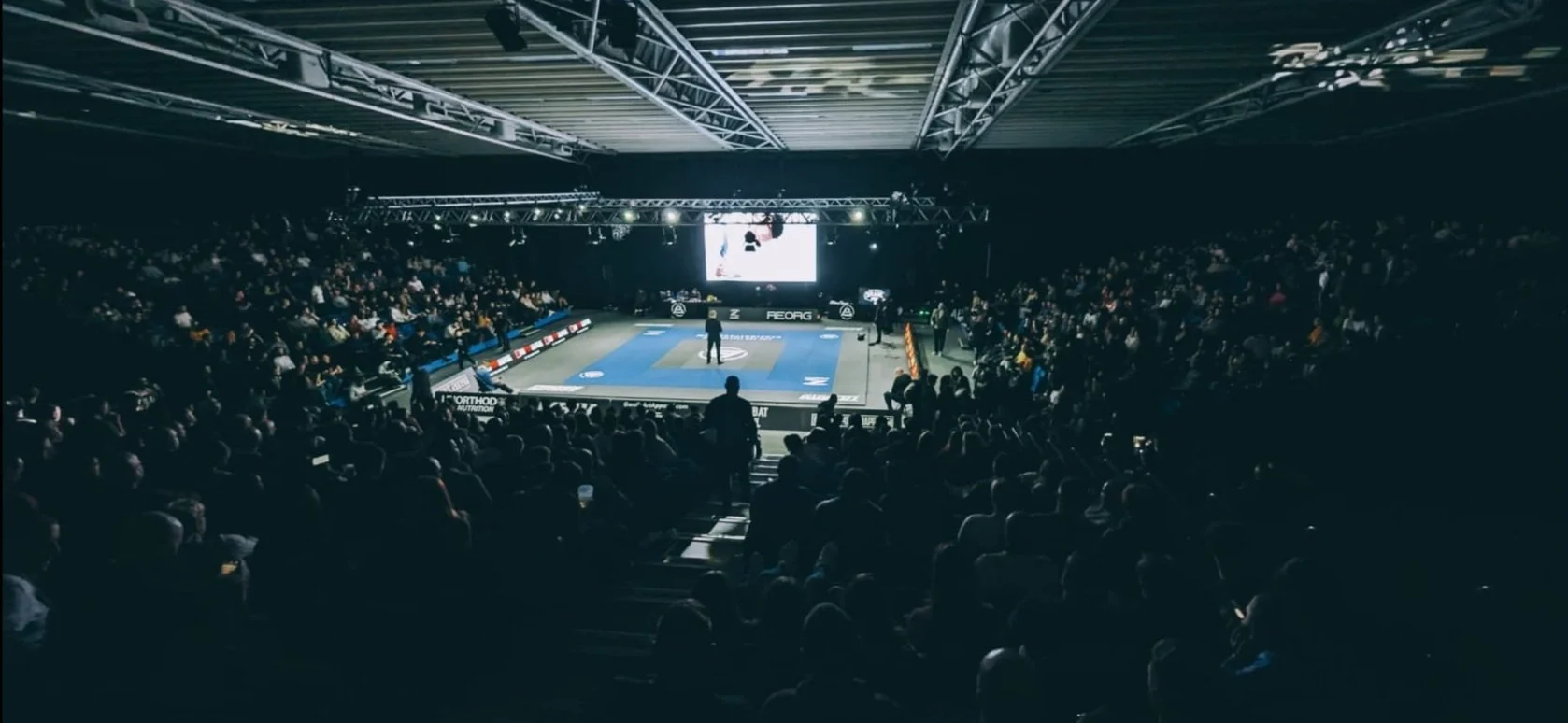 A packed arena watching a match at a Polaris event