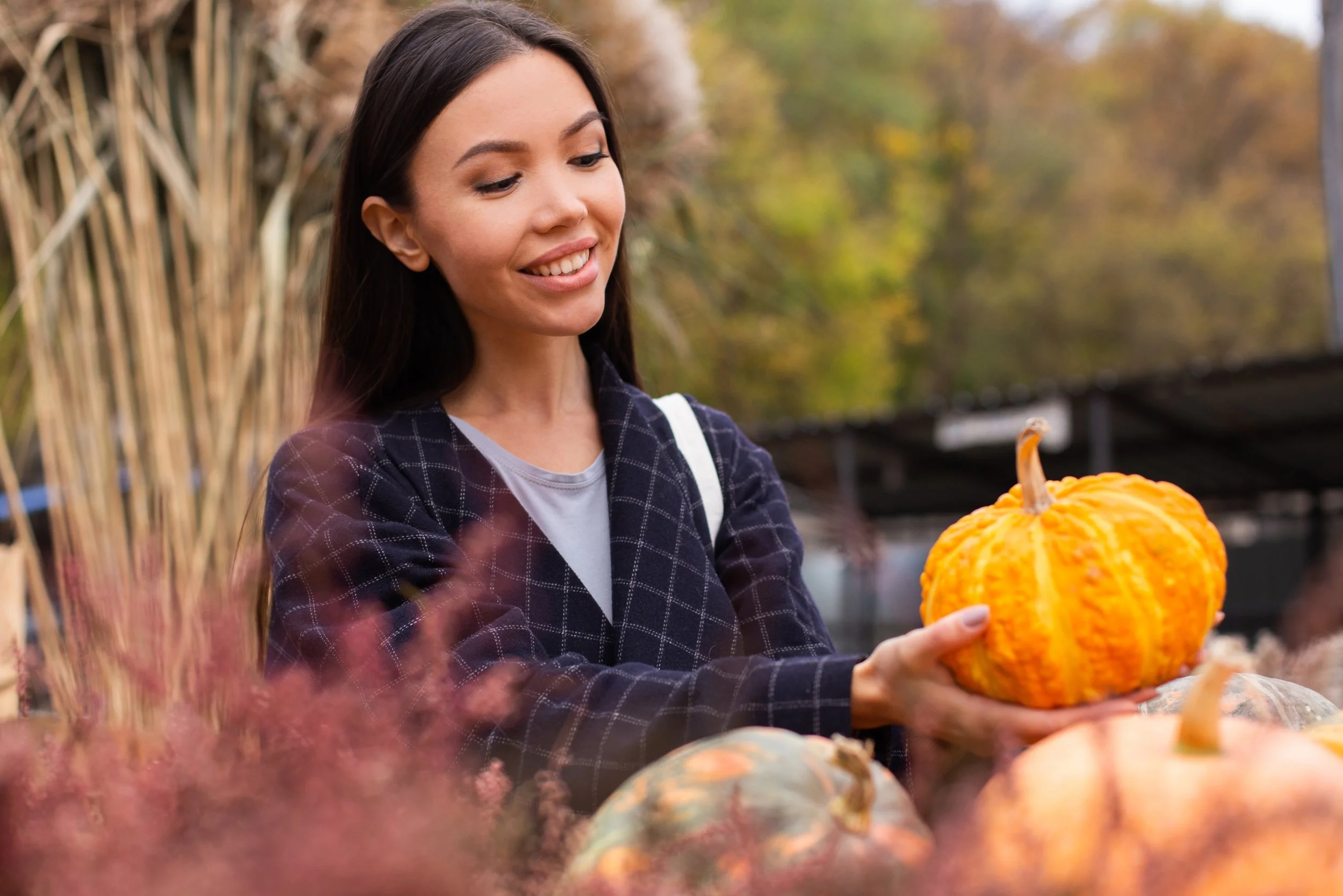 happy woman holding a pumpkin
